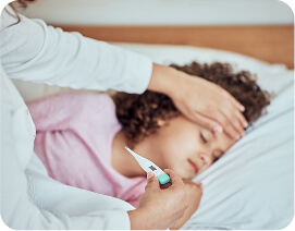 Woman lying in bed measuring her temperature while experiencing fever symptoms.